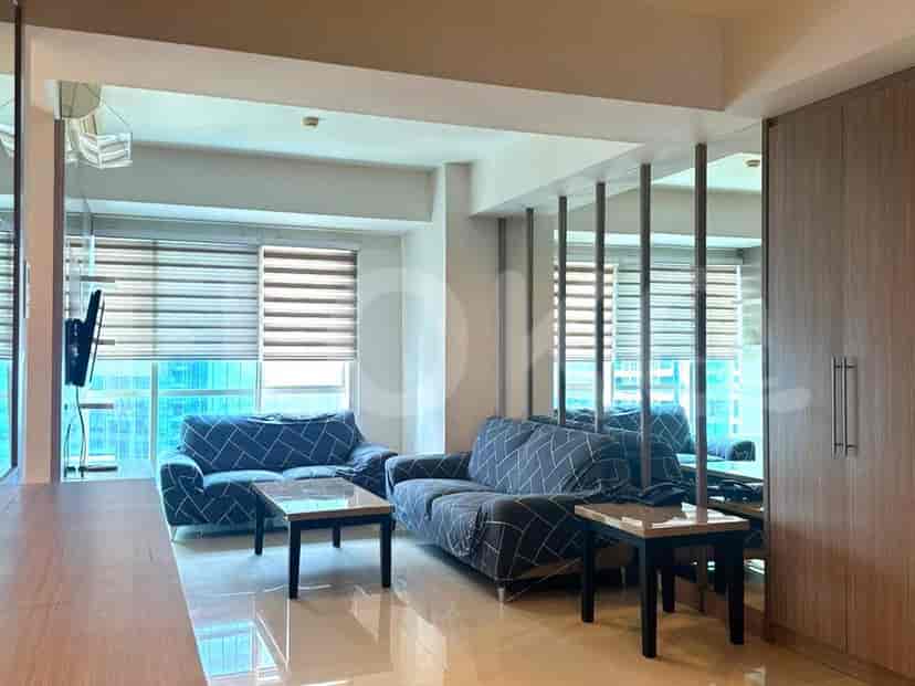 Dining area with a glass-top table and chairs, and a well-equipped kitchen.