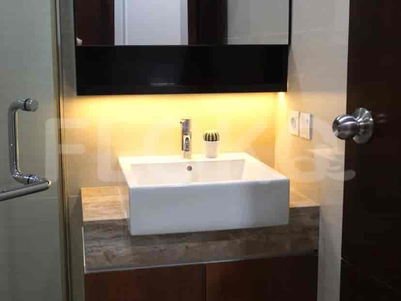 Bathroom with a sink, mirror, and a shower area.