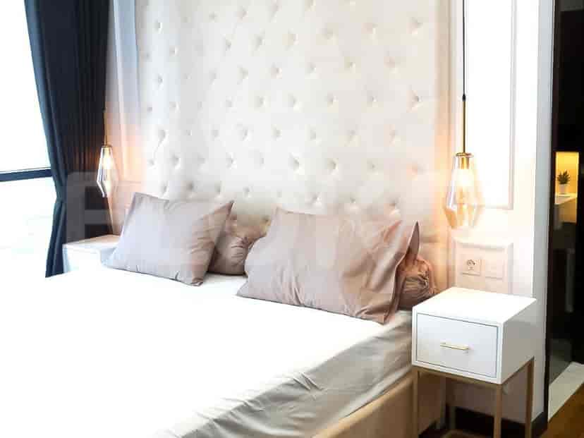 Bedroom with a large bed featuring a tufted headboard and stylish bedside lamps.