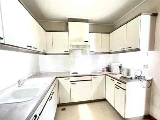 Kitchen with white cabinets and appliances.