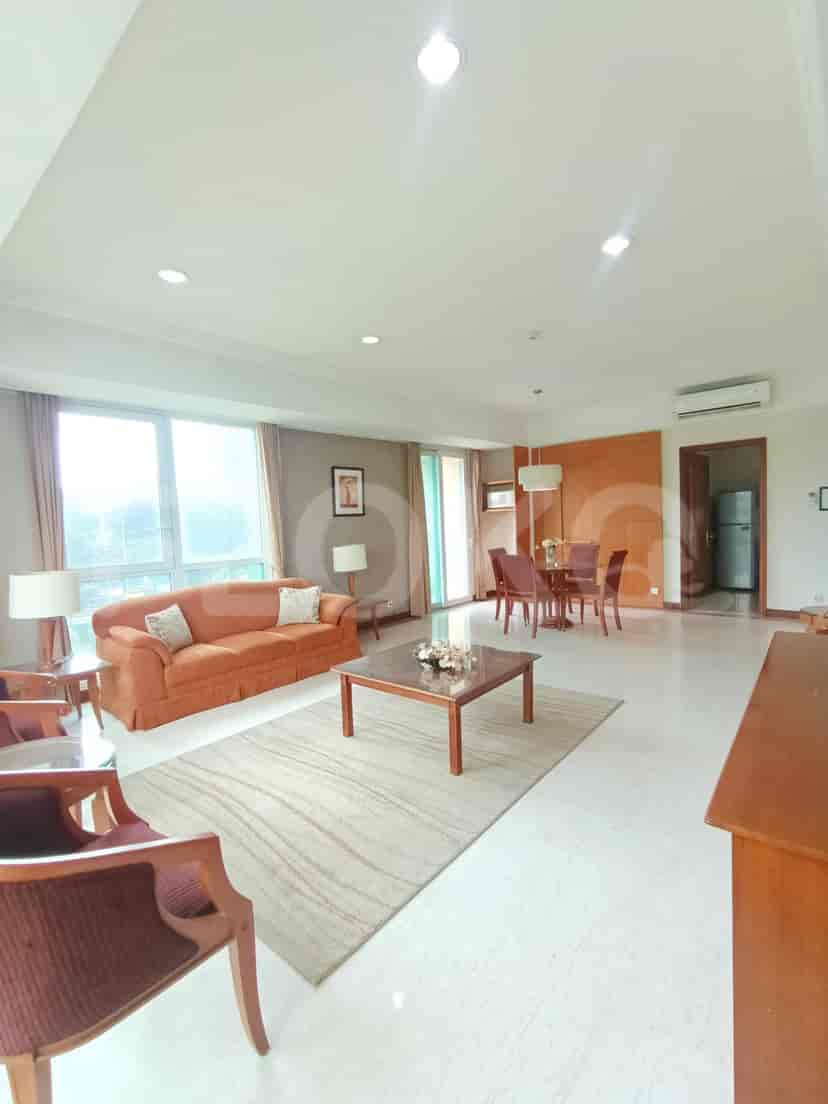 A living room with a sofa and dining area.
