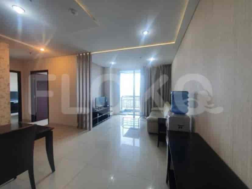 Living area connected to a balcony, showing a smart TV.