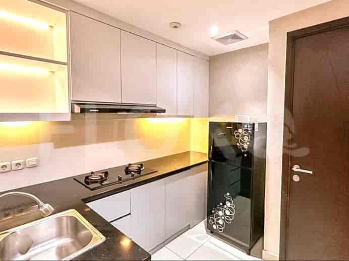 Compact, modern kitchen with gray cabinets and stainless steel appliances.
