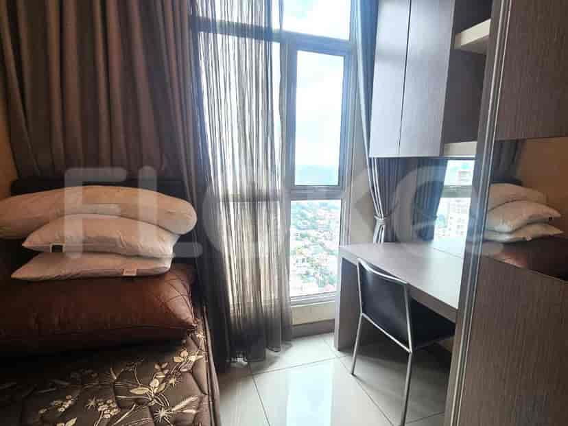 Bedroom with a single bed, desk, and city view.