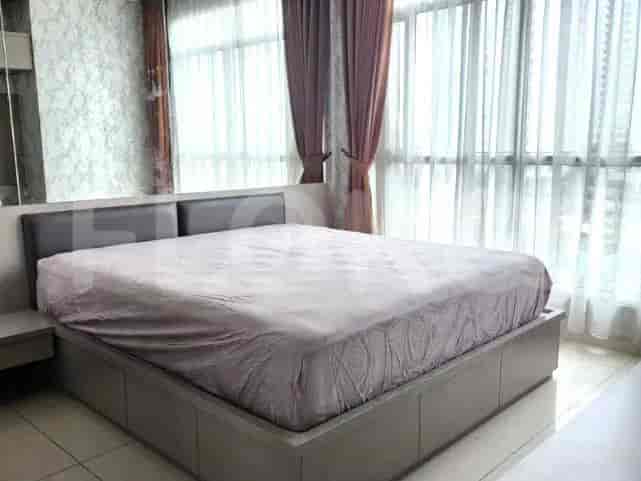 Bedroom with a queen-size bed, neutral color palette and a large window with curtains.