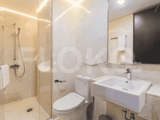 A modern bathroom with a shower, toilet, and sink.