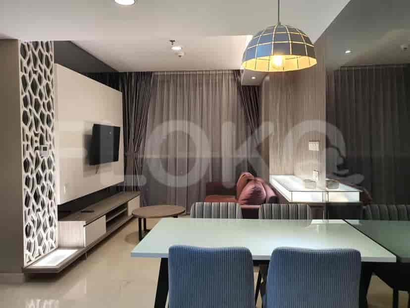 A living room with a dining area, TV, and stylish decor.