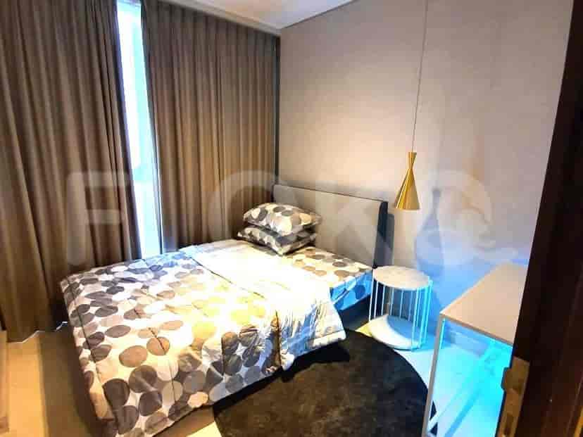 Simple bedroom design with a bed, side table, and a neutral color scheme.