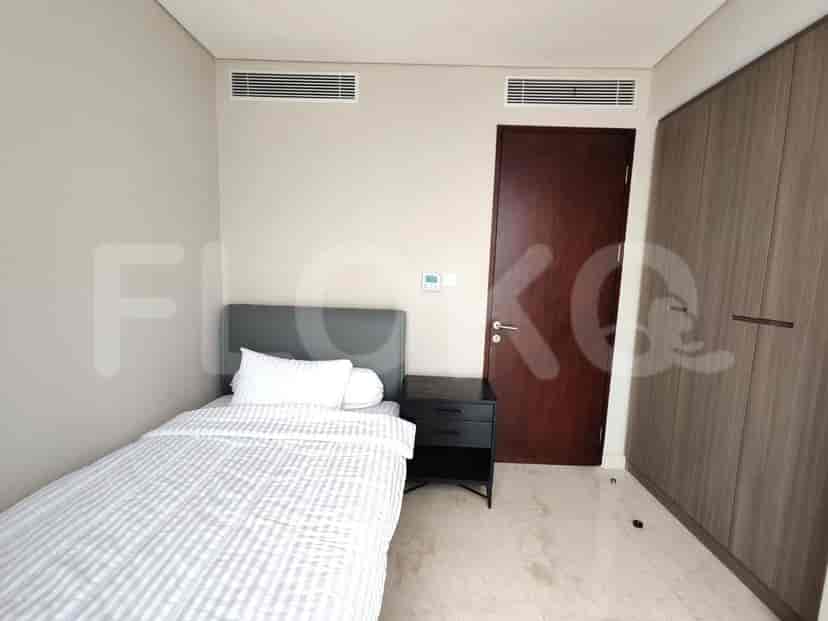 A master bedroom with a king bed and a mounted smart TV.