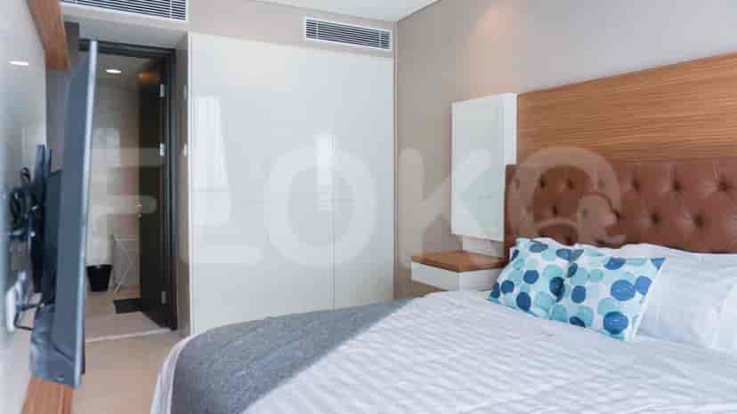 Bedroom with a bed, TV, and access to a bathroom.