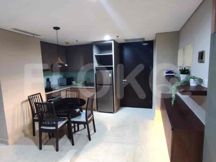 Kitchen area with a dining table and a small kitchen.