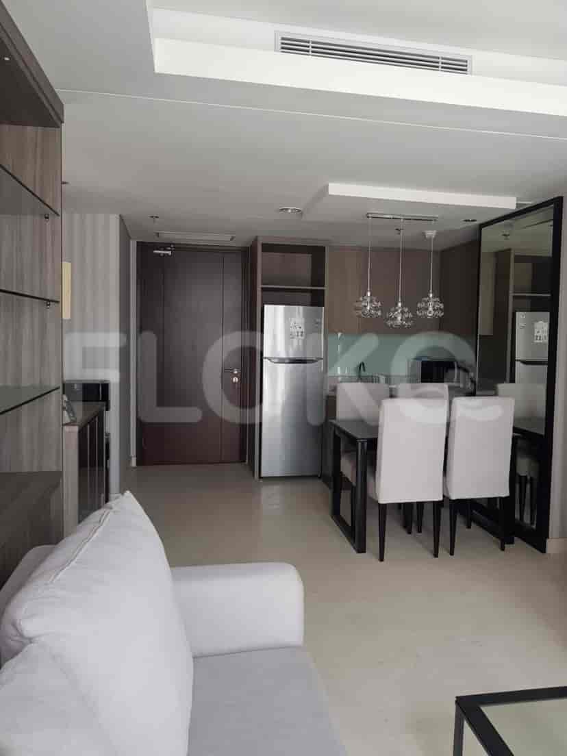 Combined living room and kitchen space with modern furnishings.