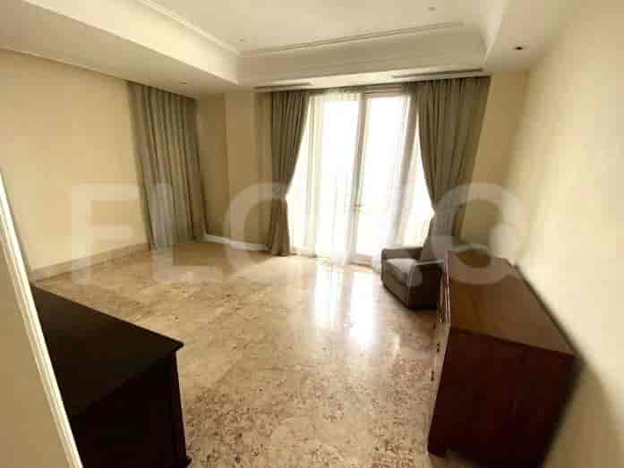 Bedroom with a chest of drawers and large window.