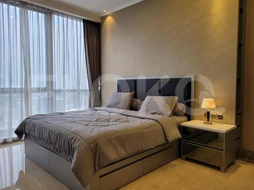 Modern bedroom featuring a bed, large windows, and a neutral color palette.