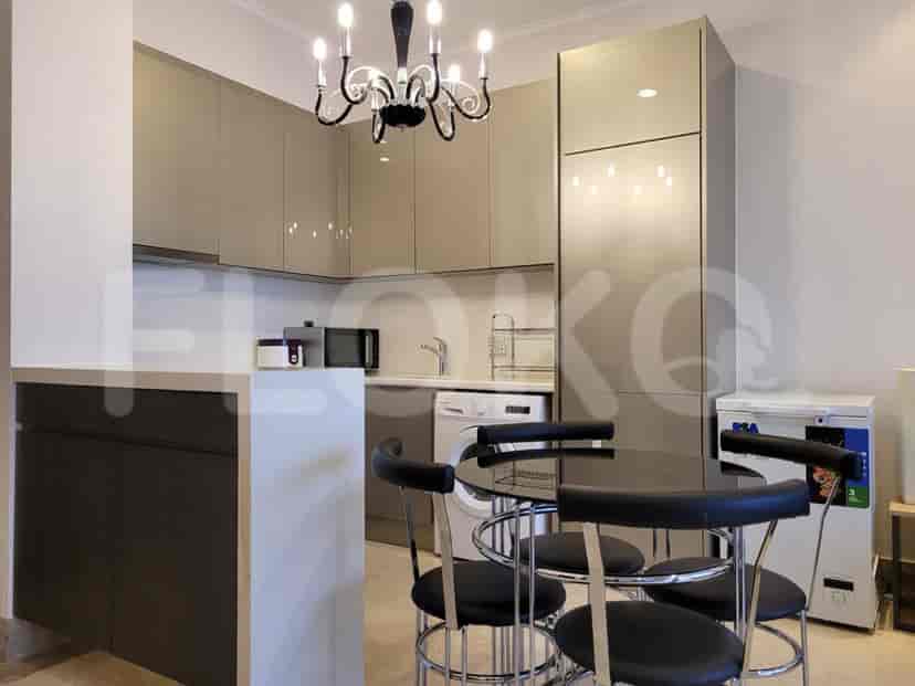 Modern kitchen with cabinets, appliances, and a dining area.