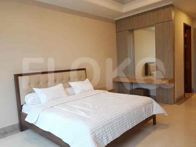 Elegant bedroom with a large bed, vanity, and soft lighting.