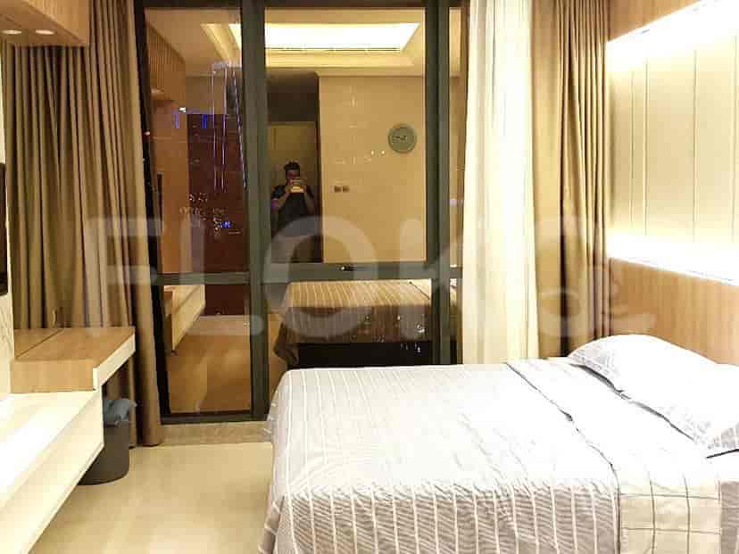 Bedroom with large window offering city view.