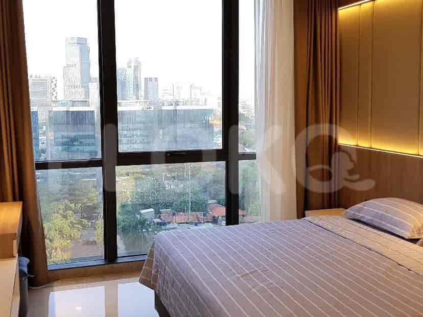 Bedroom with bed, window and city view.