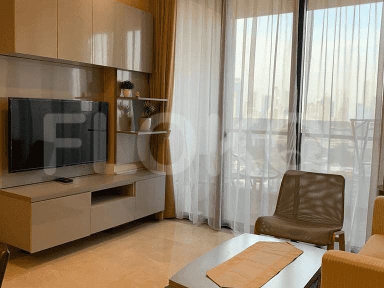 The living room with a TV, chair, and view.