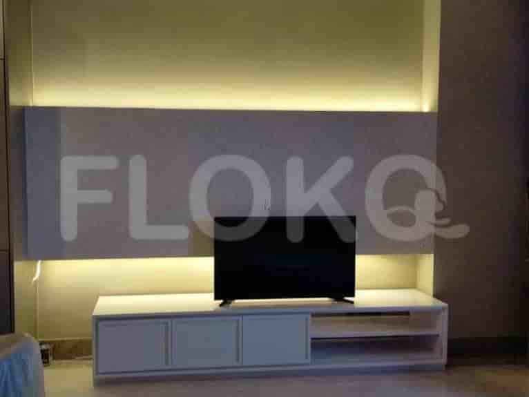 A stylish living area with a mounted TV and a white media console.