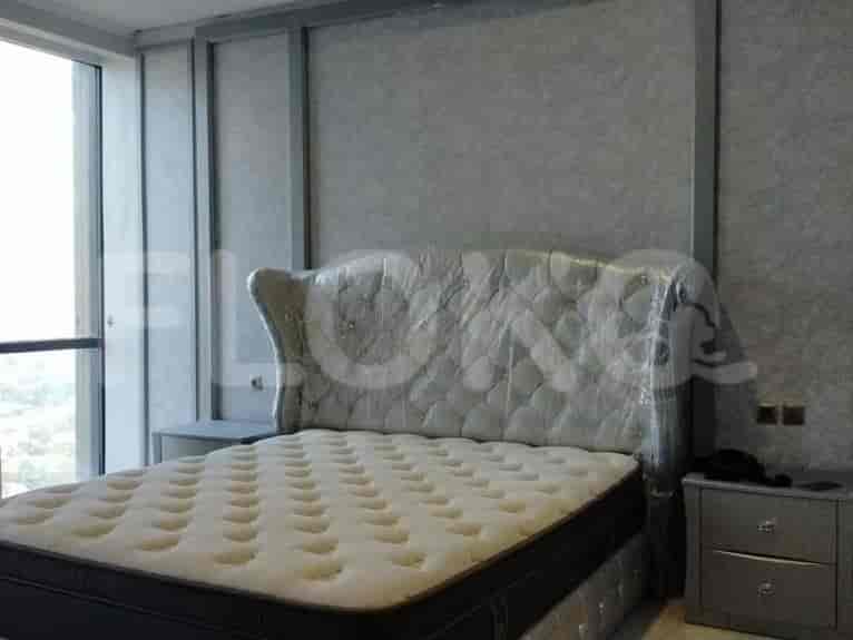 A contemporary bedroom featuring a large bed with a padded headboard.