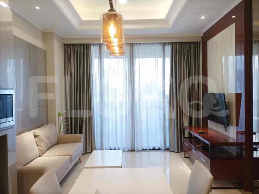 Modern living room with a beige sofa, dining table, and city view.