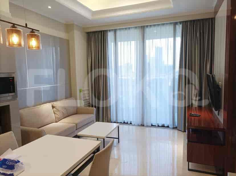 Living room with sofa, dining table, and window view.