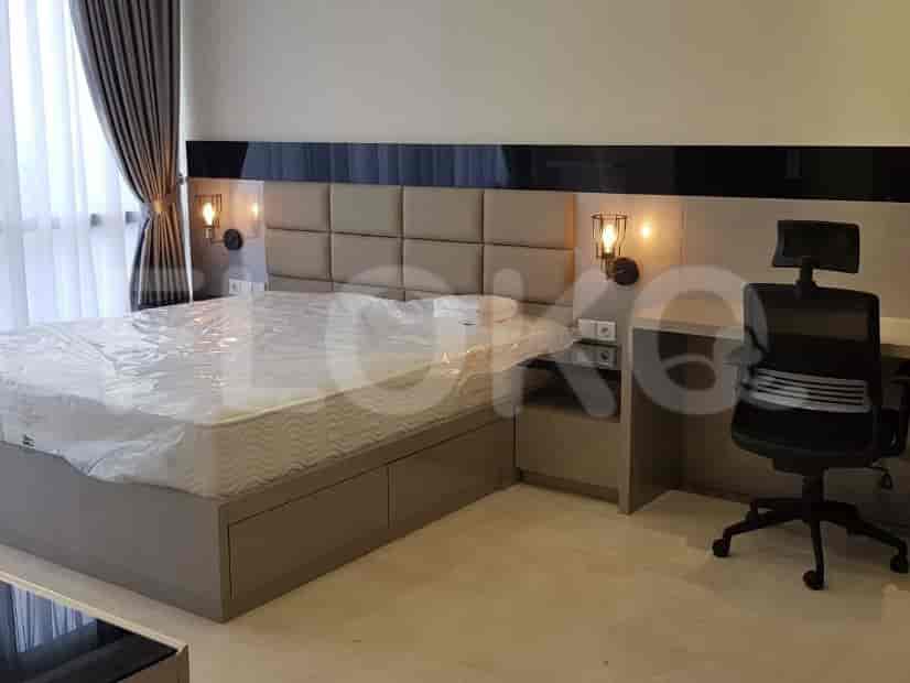 Bedroom with a bed, desk, and wall-mounted lamps.