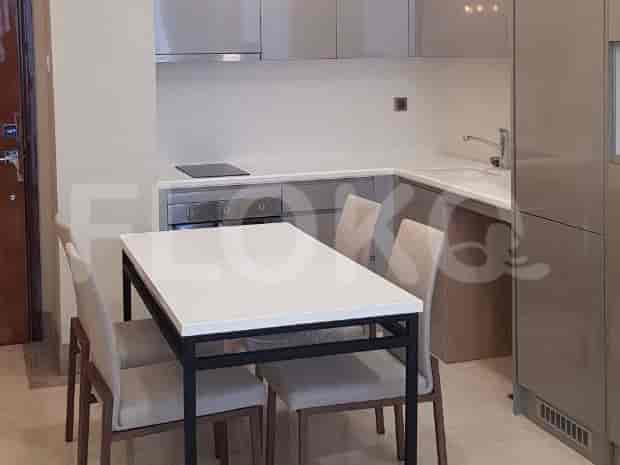 Modern kitchen with cabinets, a dining table, and built-in appliances.