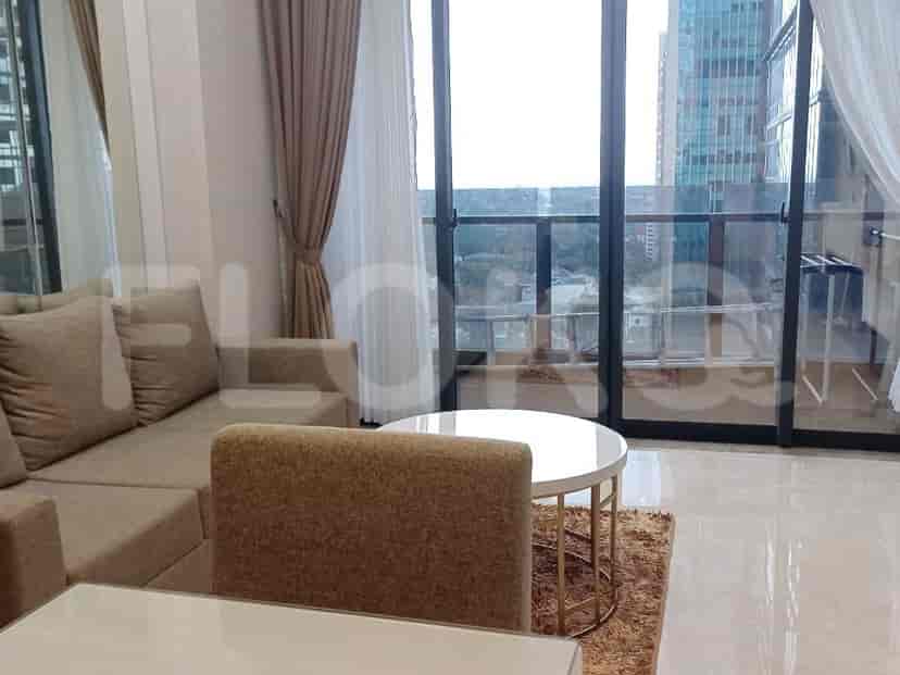 Living room with a sectional sofa, round coffee table, and balcony with city view.
