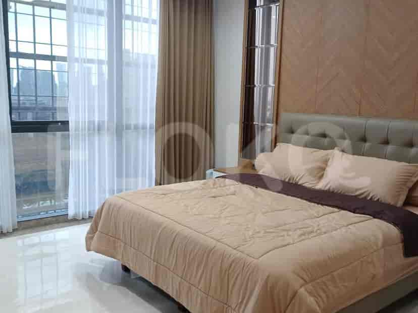 Bedroom with a bed, curtains, and a wall-mounted decorative panel.
