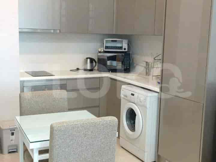 Modern kitchen with cabinets, appliances, and a dining table.