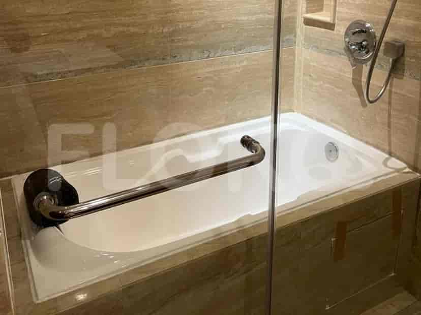 Bathroom with a bathtub and tiled walls.