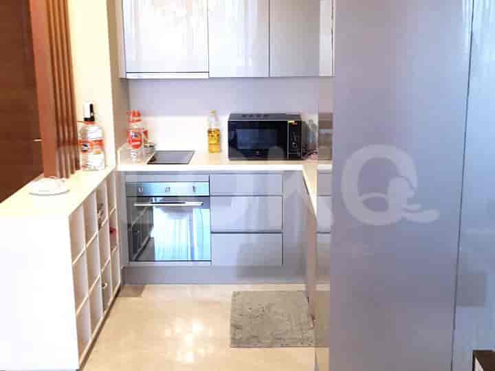 A modern kitchen with stainless steel appliances and white cabinets.