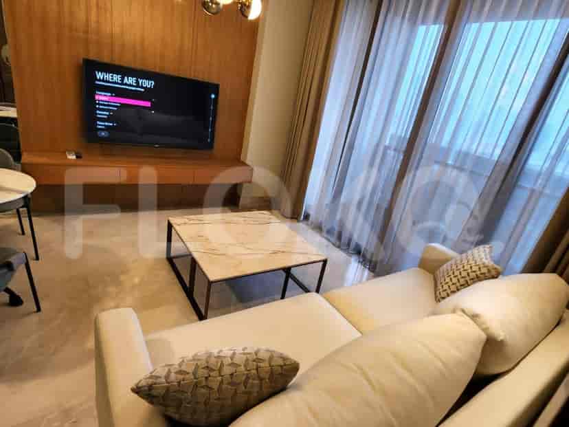Modern living room with a marble coffee table, cream sofa, and wall-mounted TV.