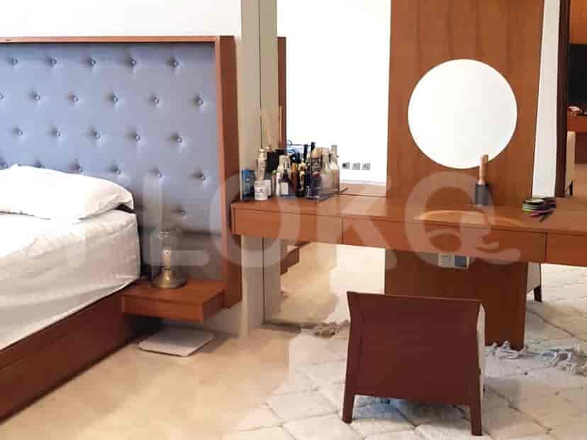 A close-up view of a dressing table with a round mirror and accessories.