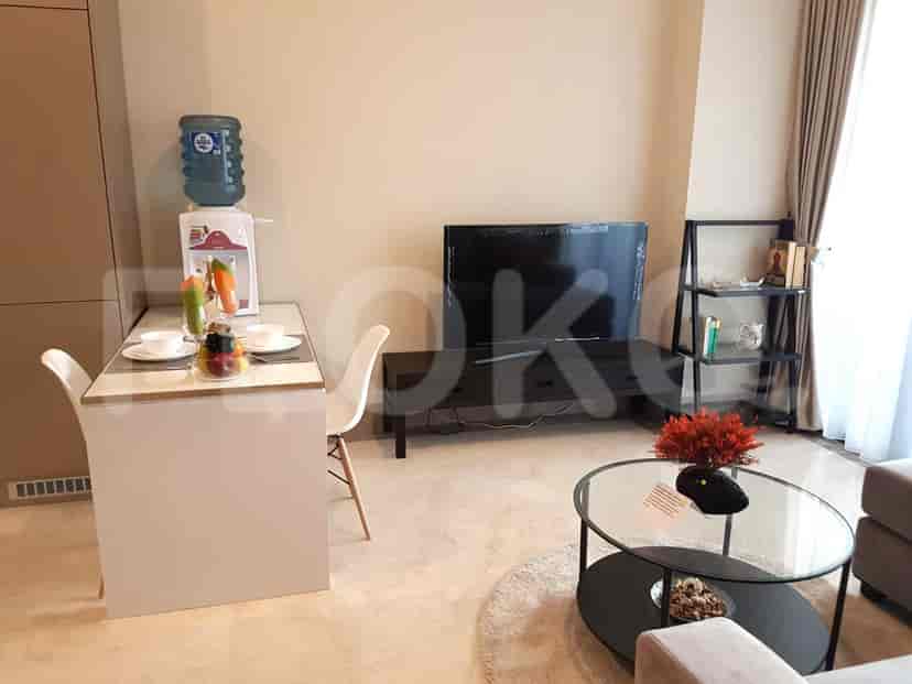 Living room setup with a dining table, TV cabinet, and sofa.