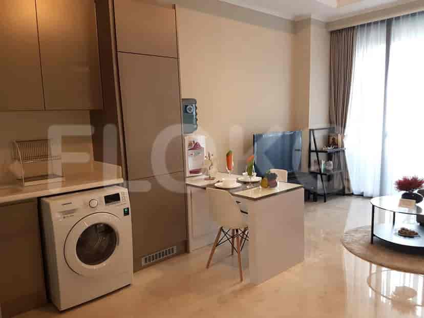 Open-plan kitchen and dining area with appliances and a small table.