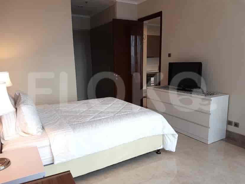 Bedroom with a bed, dresser, and access to a balcony.
