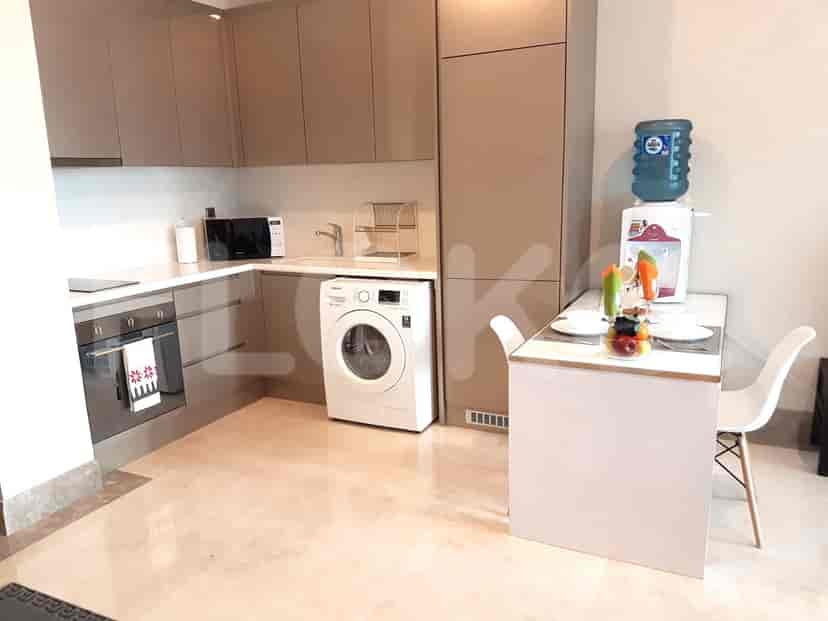Modern kitchen setup with a dining table and appliances.