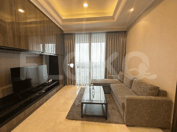 Elegant living room with a sectional sofa, wall-mounted TV, and city view.