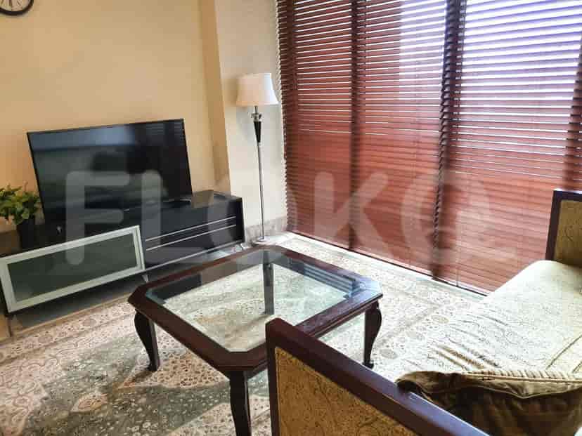 Living room with a glass-top table, TV, and blinds.