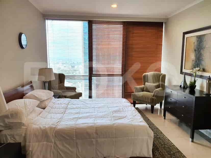 Bedroom with a large bed, blinds, and a dresser.