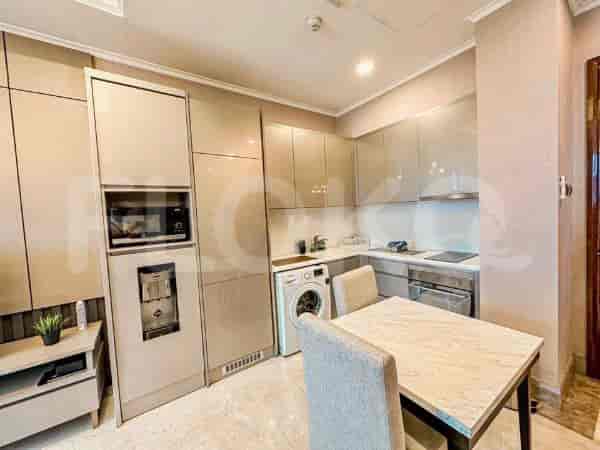 A modern kitchen featuring built-in appliances and a dining area.