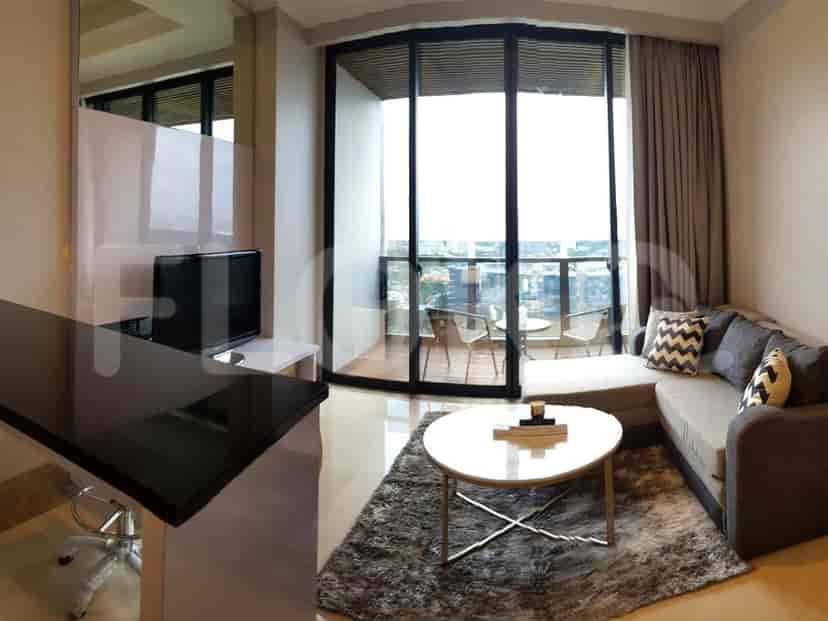Modern living room with a grey L-shaped sofa, TV, and balcony access.