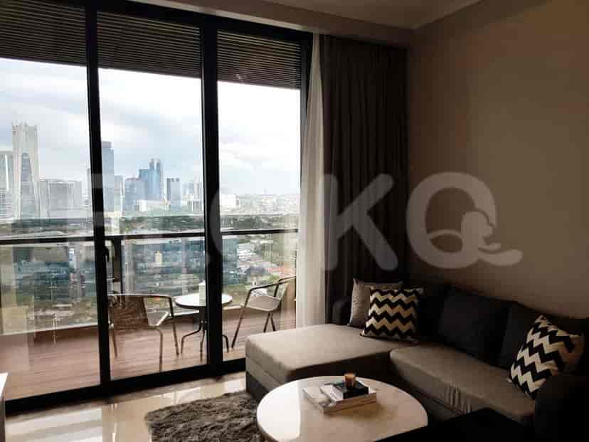 Living room showcasing balcony access with a city view and a grey sectional sofa.