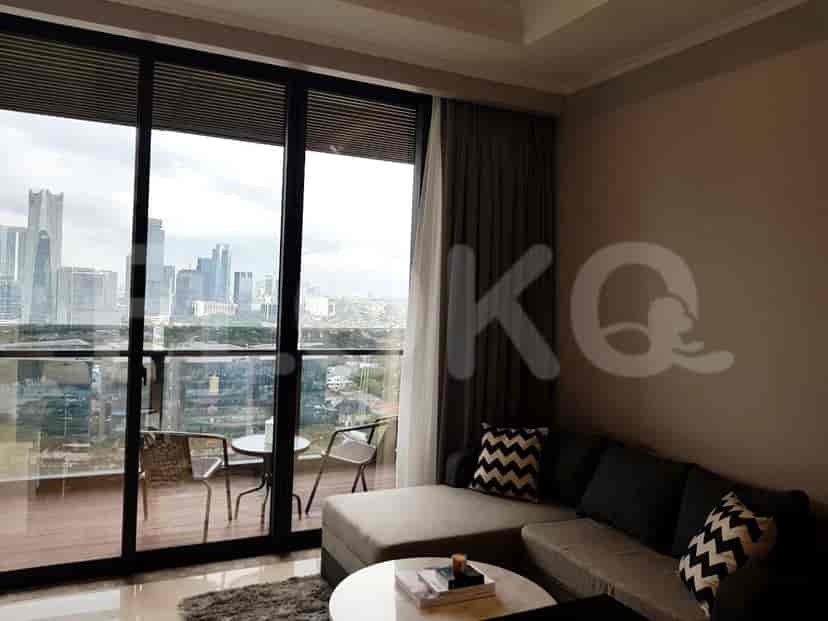 Living room with city view and balcony with two chairs.