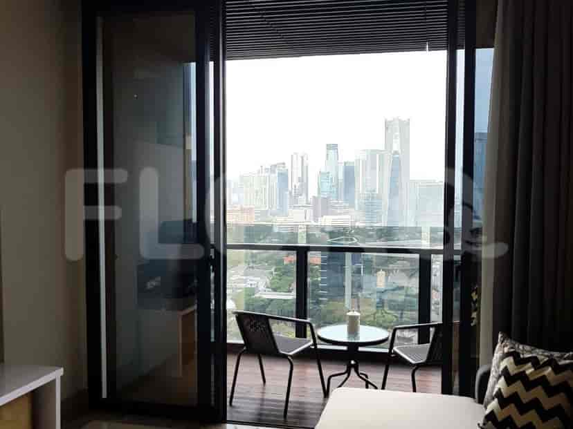 Balcony with city view and two outdoor chairs with a table.