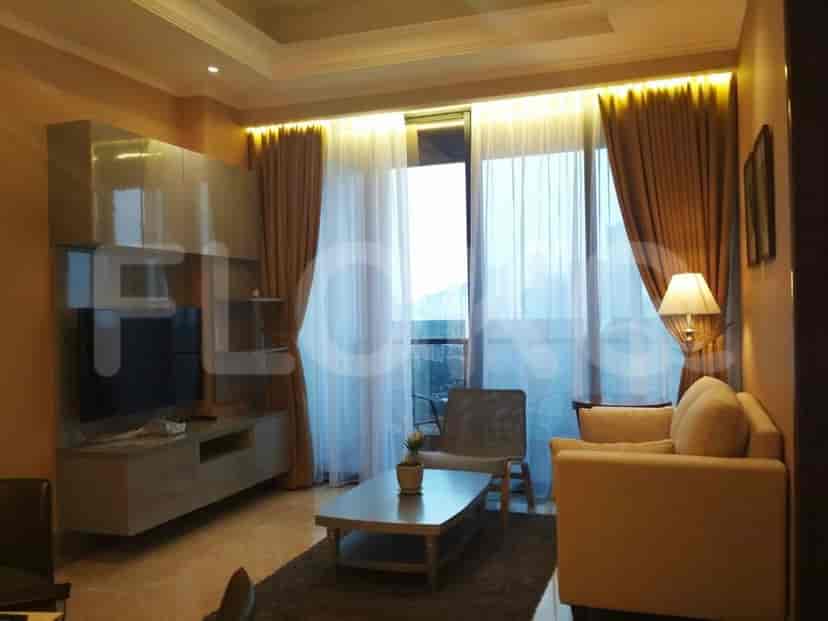 Living room with a sofa, entertainment unit, and large window.