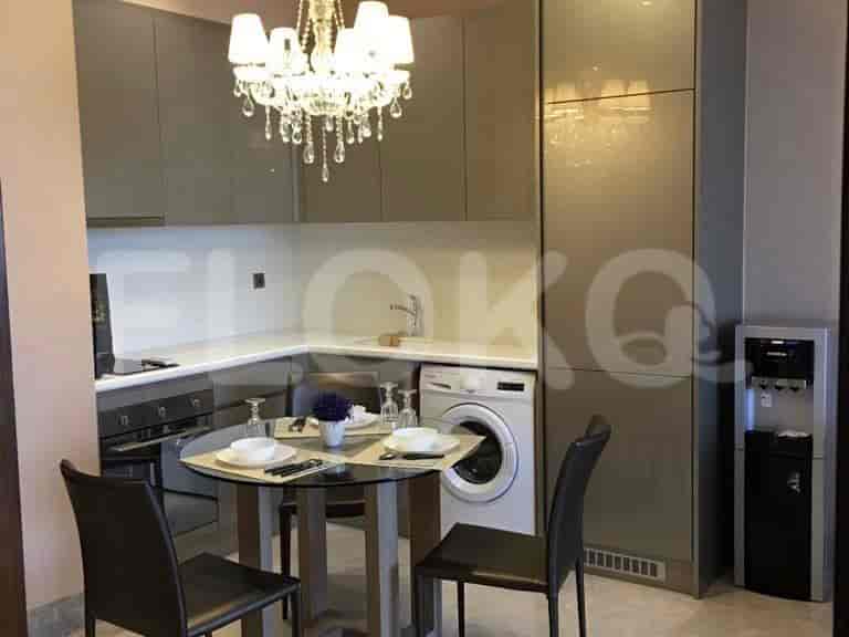 Kitchen and dining area with a table, cabinets, and appliances.